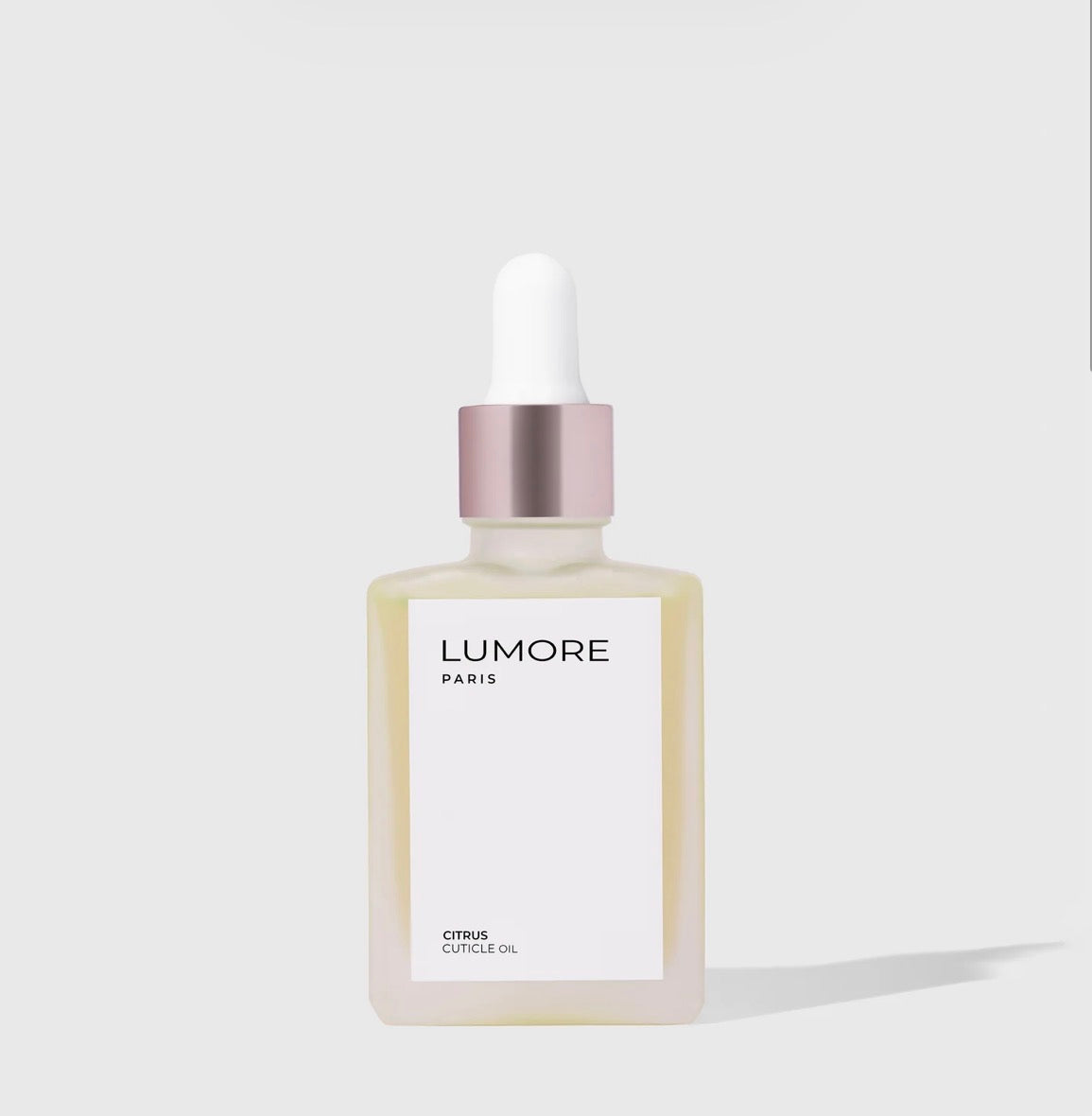 Lumore Paris cuticle oil bottle with dropper on a light gray background
