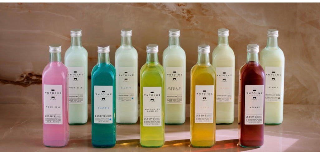 Row of colorful bottles with labels on a wooden surface